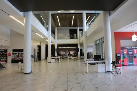 Image of the main floor of the downtown library, wide open space with columns and marble looking floor